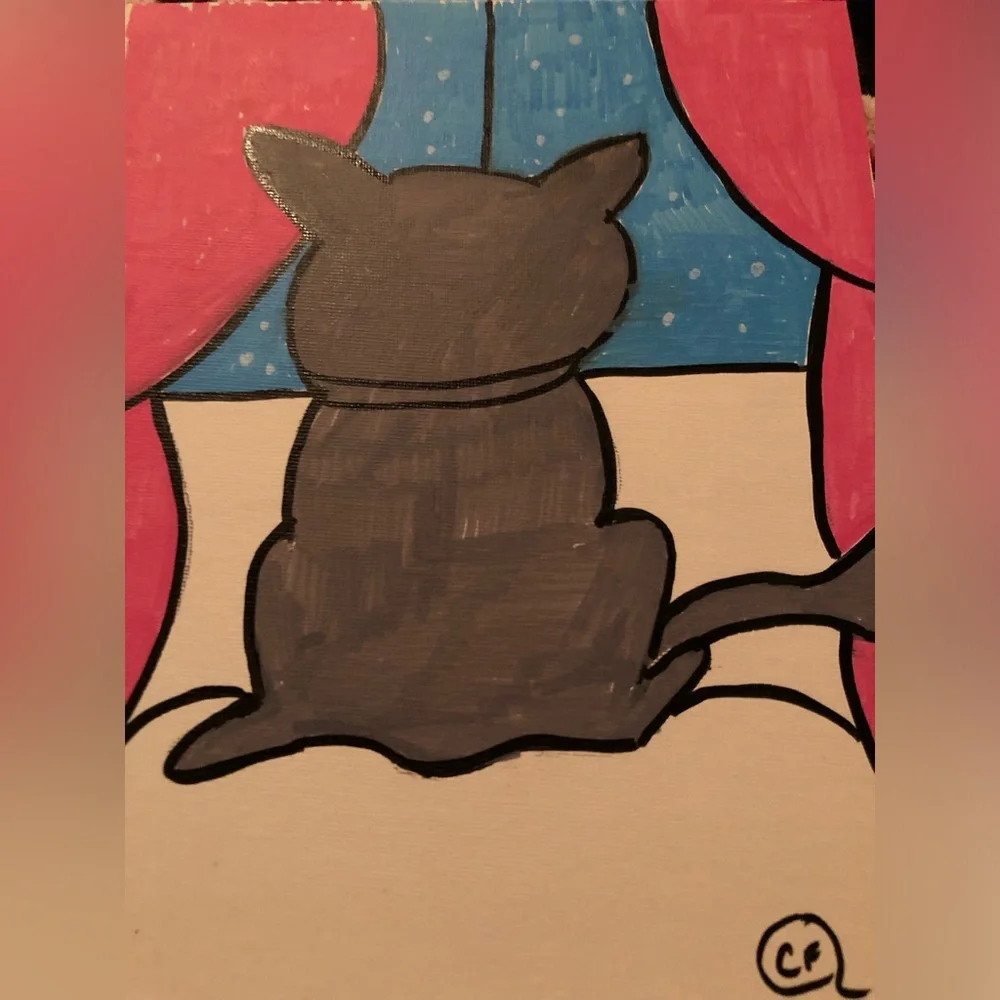 Beautiful gray cat looking out of the window on snowy day